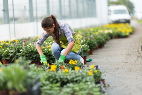Gardener wearing protective gear with tools in hand